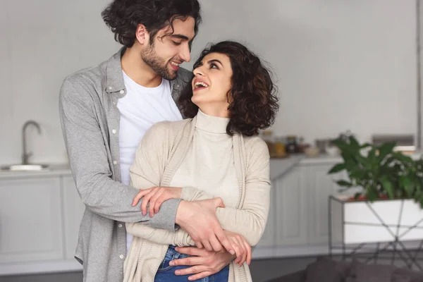 Boyfriend Hugging Smiling Girlfriend Home — Free Stock Photo