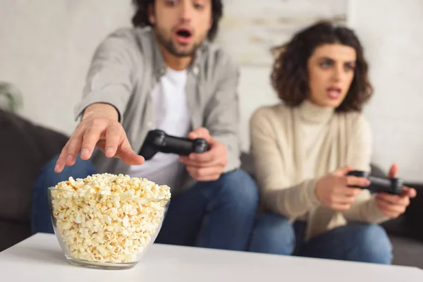 Young Couple Playing Video Game Man Reaching Out Popcorn Home — Stock Photo, Image