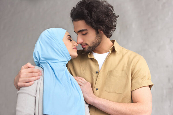 tender muslim couple going to kiss at home