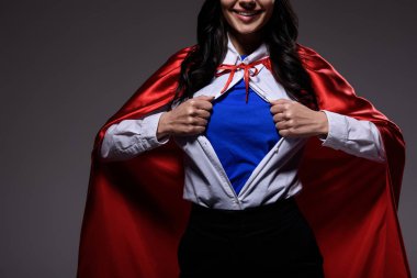 cropped image of super businesswoman in red cape showing blue shirt isolated on black clipart