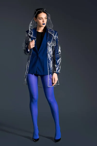 Stylish Woman Blue Pantyhose Transparent Raincoat Dark Background — Stock Photo, Image