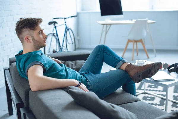 Side View Handsome Young Man Sitting Couch Looking Away Home — Stock Photo, Image