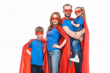 super family in masks and cloaks looking at camera isolated on white  clipart