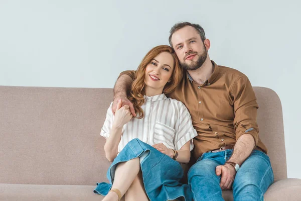 Happy Couple Sitting Couch Smiling Camera Grey — Stock Photo, Image