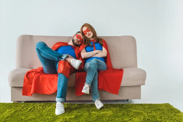 Tired Couple Superhero Costumes Sleeping While Sitting Sofa Grey — Stock Photo, Image