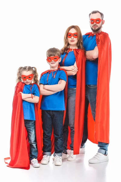 super family in masks and cloaks standing with crossed arms and looking at camera isolated on white
