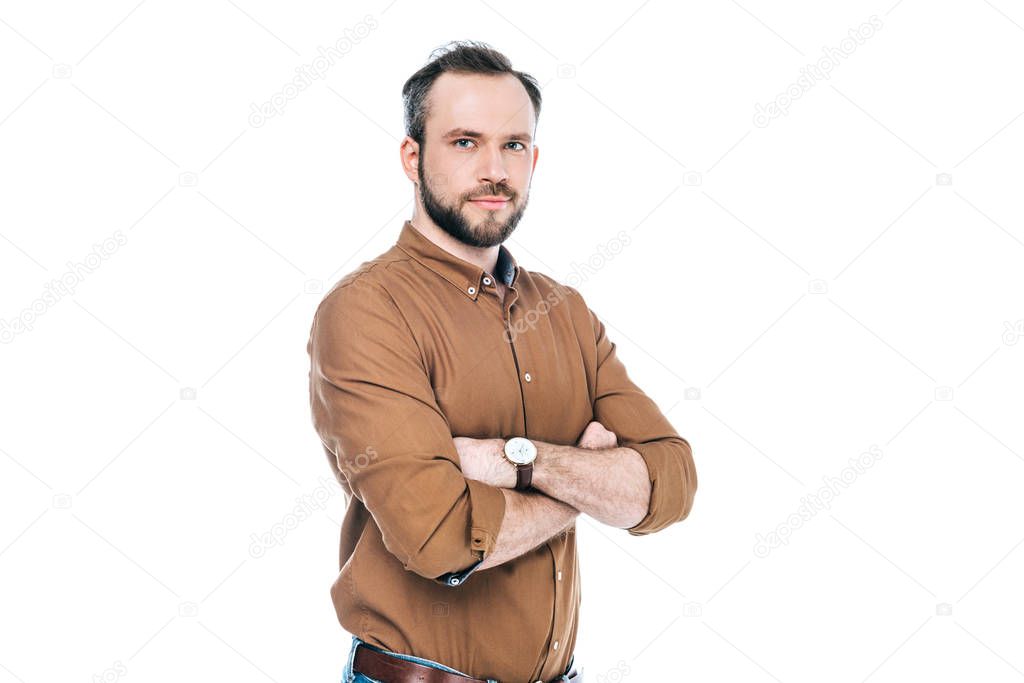 portrait of handsome bearded man standing with crossed arms and looking at camera isolated on white