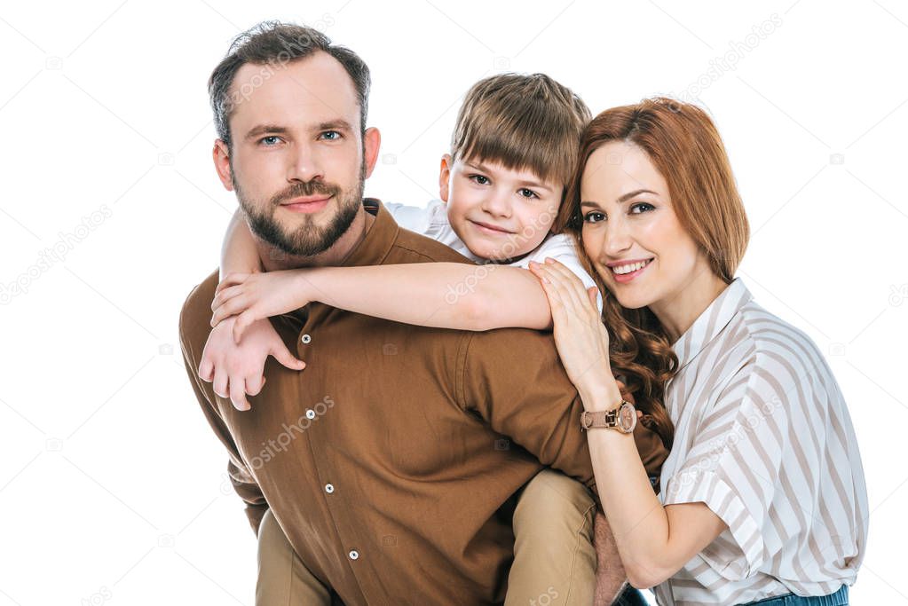 happy parents with adorable little son smiling at camera isolated on white