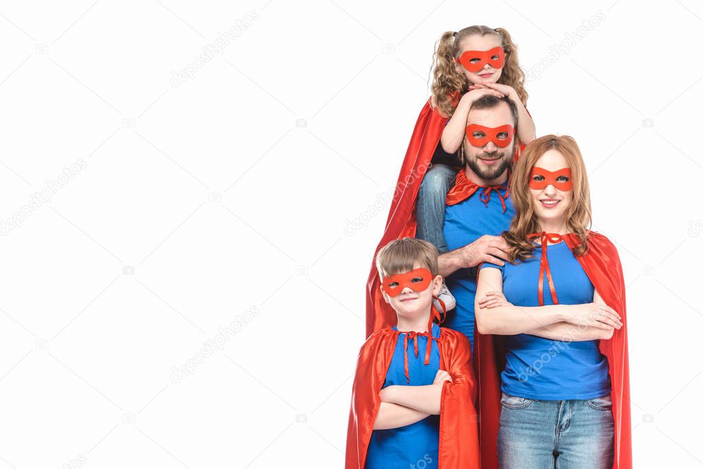 happy super family in masks and cloaks smiling at camera isolated on white 