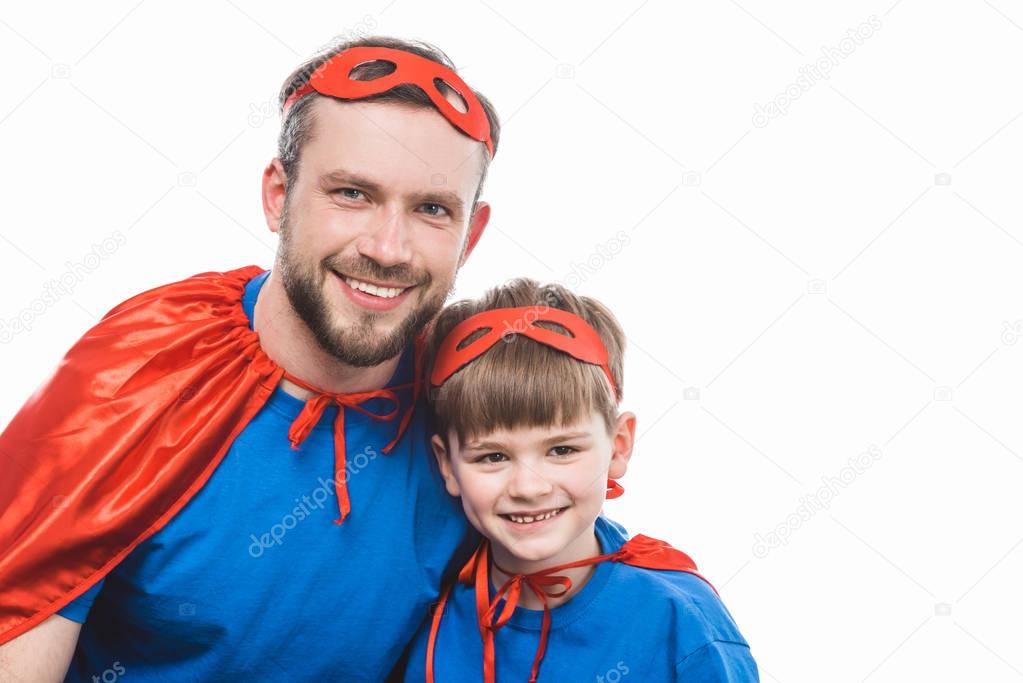 happy super dad and son smiling at camera isolated on white