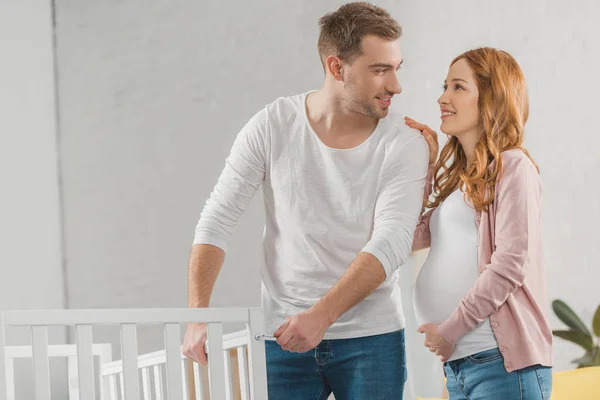 Happy Young Pregnant Couple Smiling Each Other While Standing Baby — Stock Photo, Image