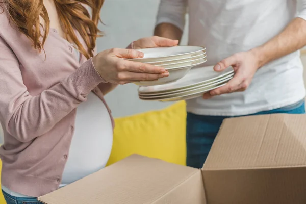 Cropped Shot Young Pregnant Couple Packing Plates Cardboard Box Relocation — Stock Photo, Image