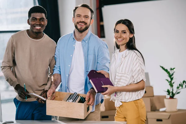 Happy Multiethnic Colleagues Cardboard Box Office Supplies Smiling Camera New — Stock Photo, Image