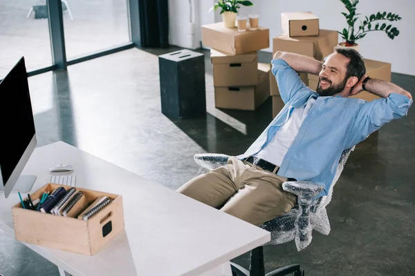 Happy Businessman Sitting Hands Head Looking Away New Office Relocation — Stock Photo, Image