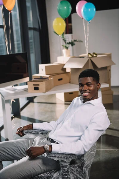 Feliz Joven Afroamericano Hombre Negocios Sonriendo Cámara Mientras Está Sentado — Foto de stock gratuita