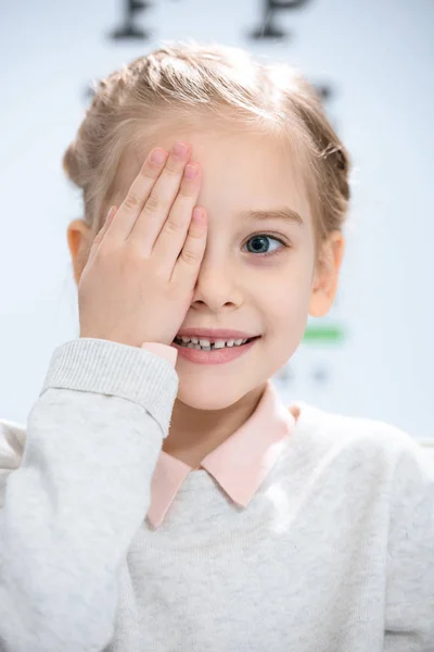 Smiling Little Kid Closing Eye Eye Chart — Stock Photo, Image