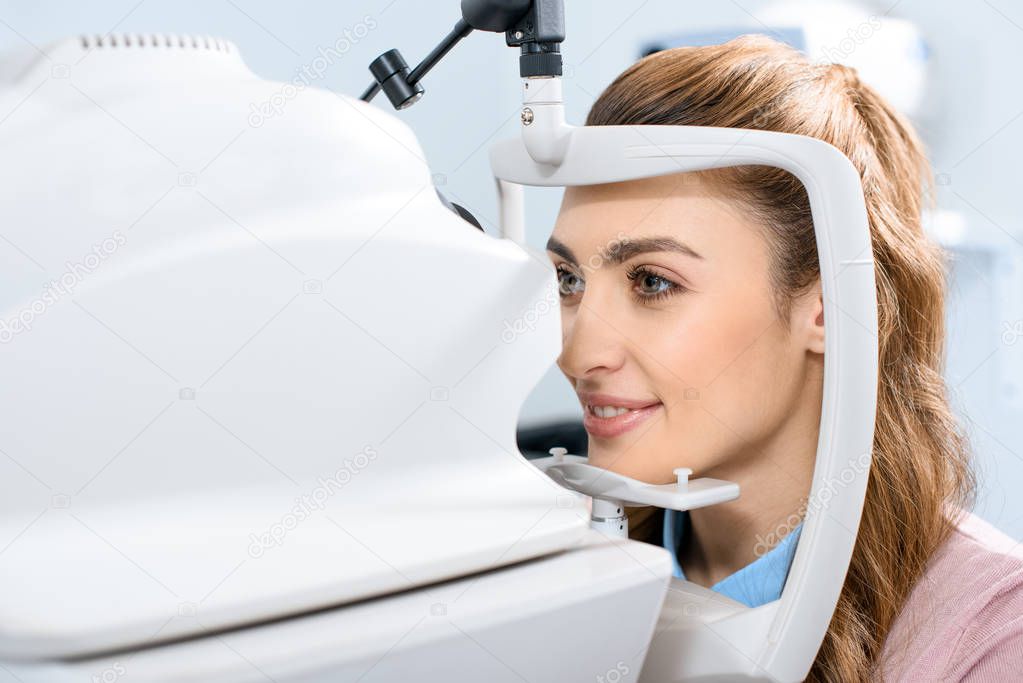 young woman at ophthalmologist consulting room examining vision