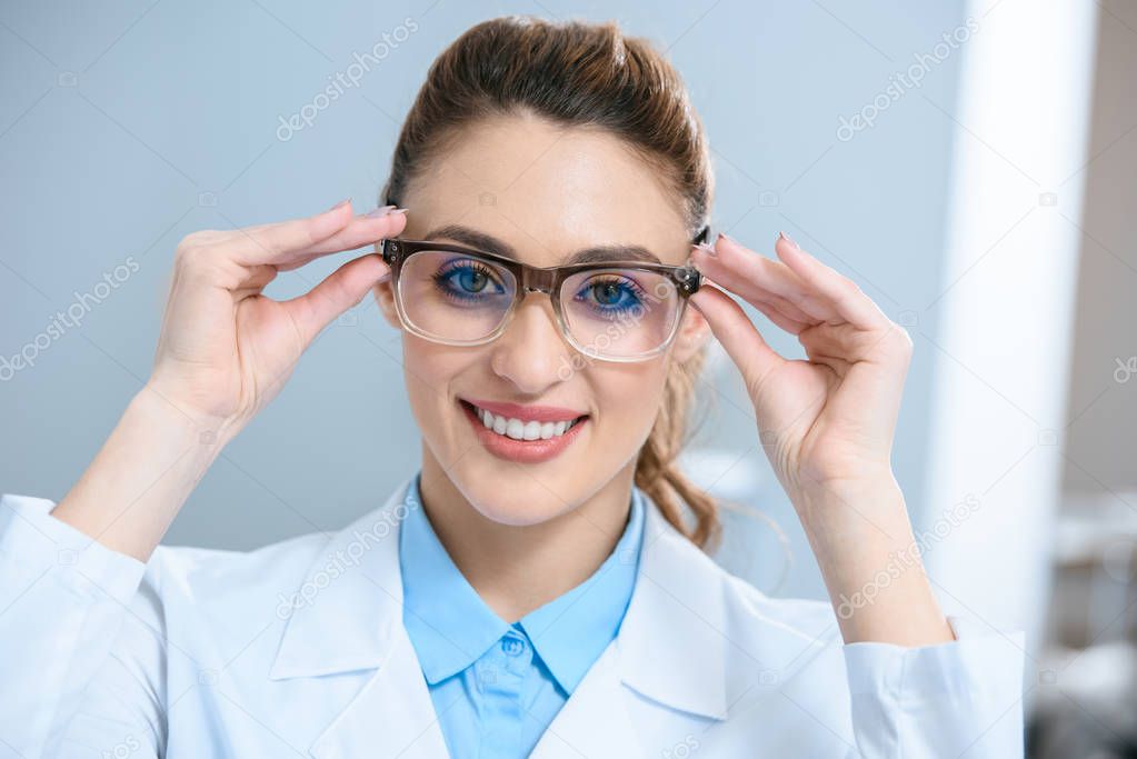 attractive smiling ophthalmologist wearing eyeglasses