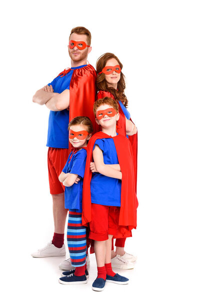 super family in costumes standing with crossed arms and looking at camera isolated on white