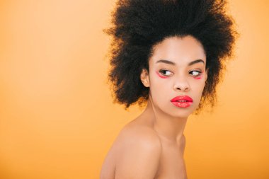 attractive african american woman with creative red makeup isolated on yellow clipart