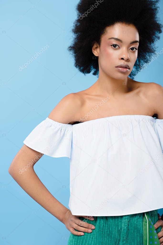 african american woman in fashionable off-the-shoulder top isolated on blue