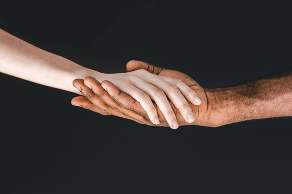 cropped image of african american boyfriend and girlfriend holding hands isolated on black