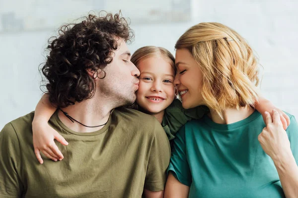 Happy Parents Kissing Adorable Smiling Daughter — Stock Photo, Image