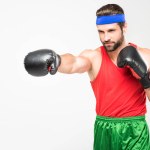 Retro athletic man in boxing gloves, isolated on white