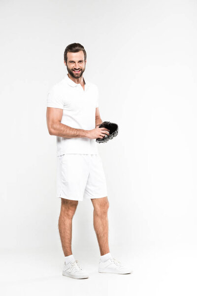 smiling baseball player with baseball glove and ball, isolated on grey