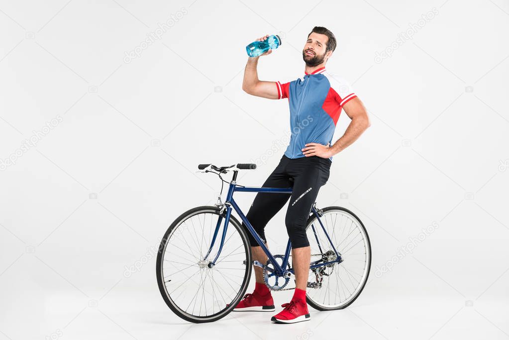 sportsman with bicycle holding sport bottle, isolated on white