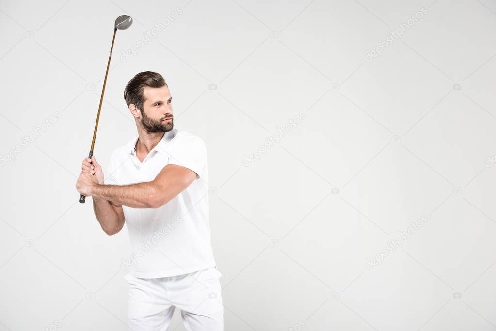 confused golf player in white sportswear with golf club, isolated on grey