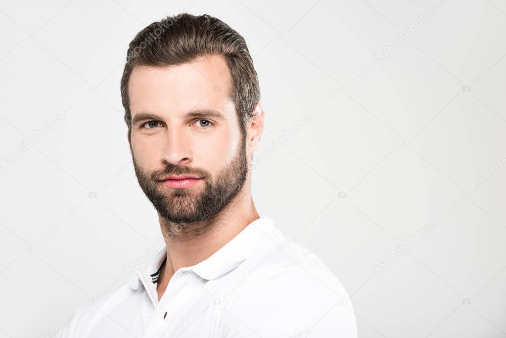 portrait of handsome bearded man looking at camera, isolated on grey