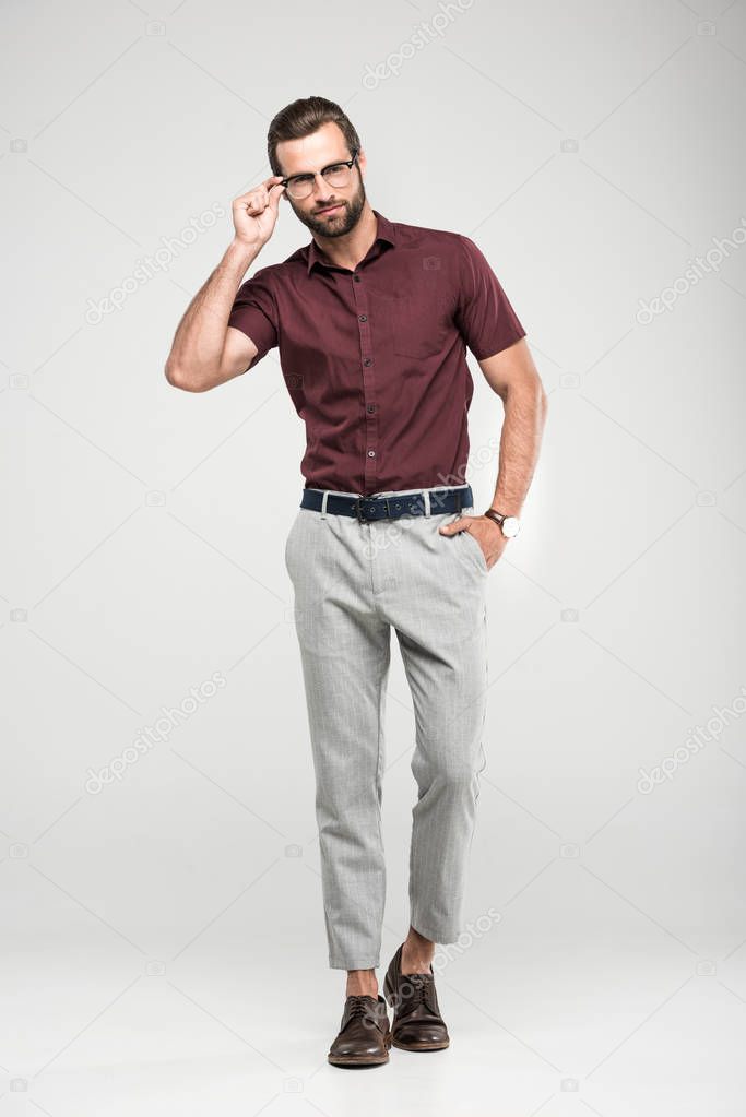 handsome man posing in casual closing and eyeglasses, isolated on grey