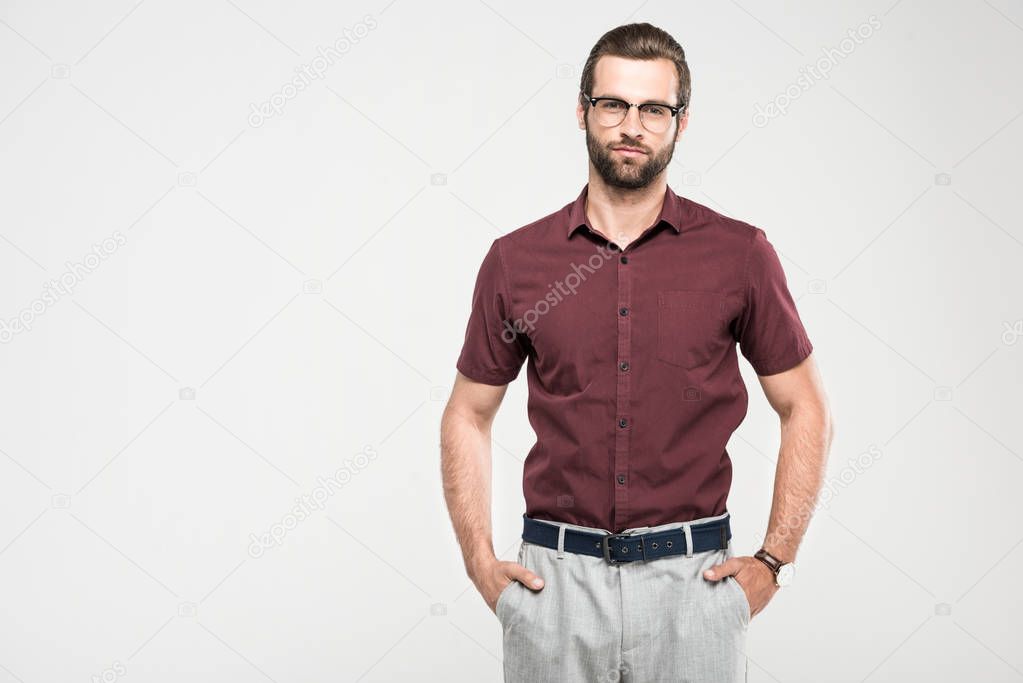 serious man posing in casual closing and eyeglasses, isolated on grey