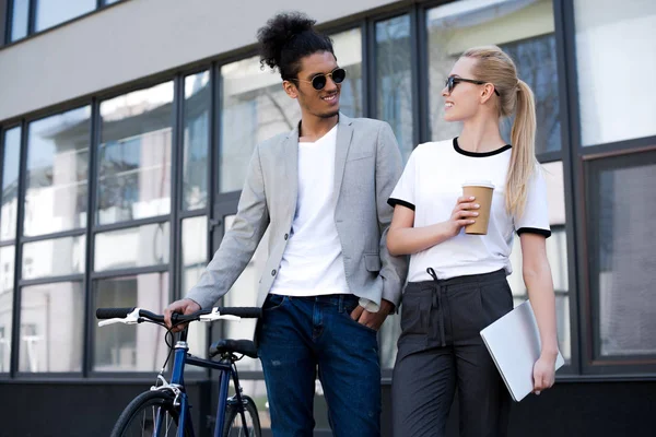 Young Multiethnic Couple Sunglasses Smiling Each Other While Standing Laptop — Stock Photo, Image