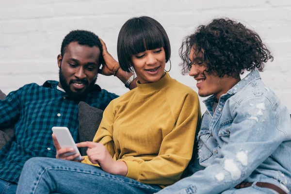 Mixed Race Woman Showing Smartphone Screen Male Friends — Stock Photo, Image