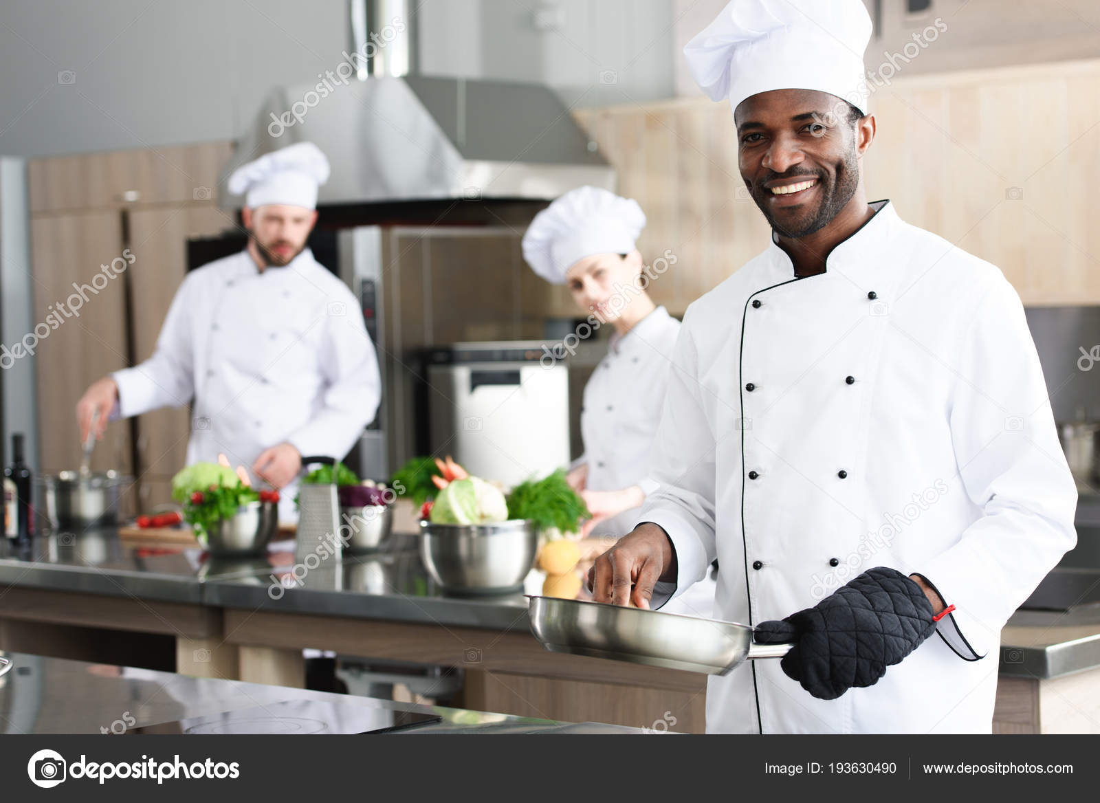 African American Chef Cooking His Multiracial Colleagues Stock Photo by  ©AllaSerebrina 193630490