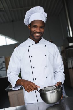 handsome african american chef at restaurant kitchen clipart