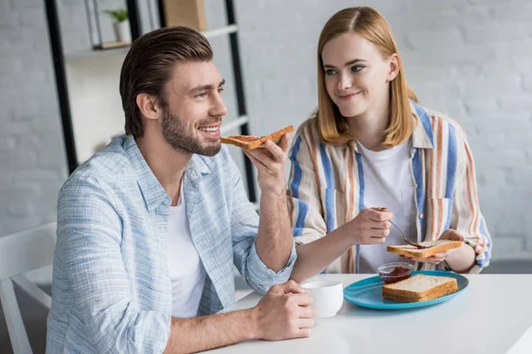 Jovem Casal Comer Torradas Com Geléia Durante Café Manhã Mesa — Fotos gratuitas