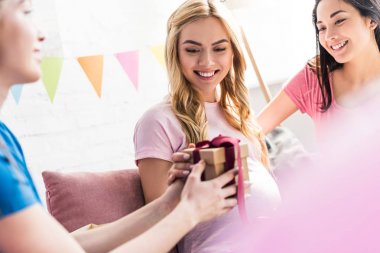 çok kültürlü arkadaşlar bebek duş parti hamile kadına hediye sunmak