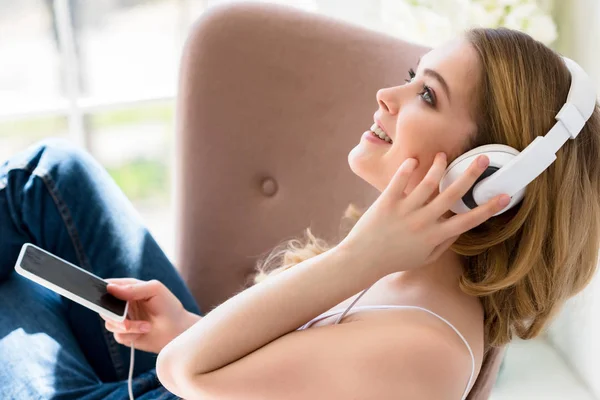 Mujer Joven Sonriente Escuchando Música Con Auriculares Smartphone Cama —  Fotos de Stock