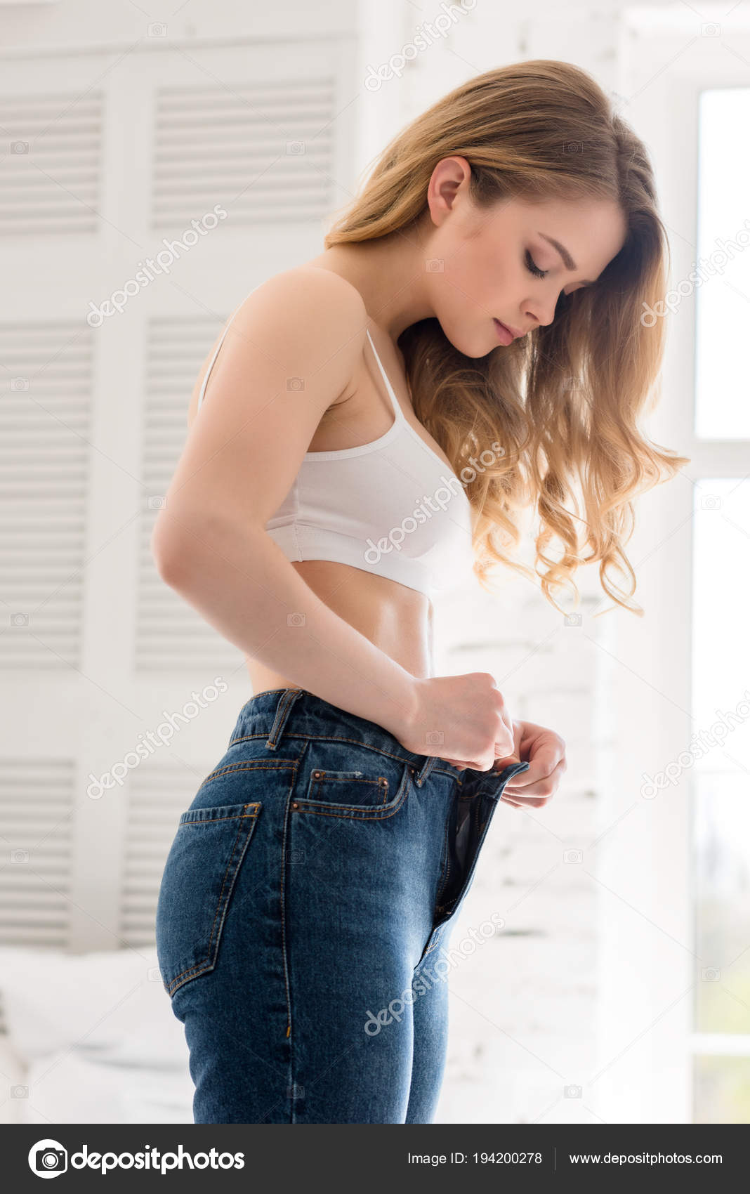 Blonde Beautiful Young Woman Wearing Jeans Stock Photo by ©AllaSerebrina  194200278