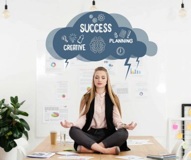 iş kadını ofiste, cloud işaretiyle yaratıcı başarı planlama içinde baş yukarıda tabloda lotus pozisyonda meditasyon sakin