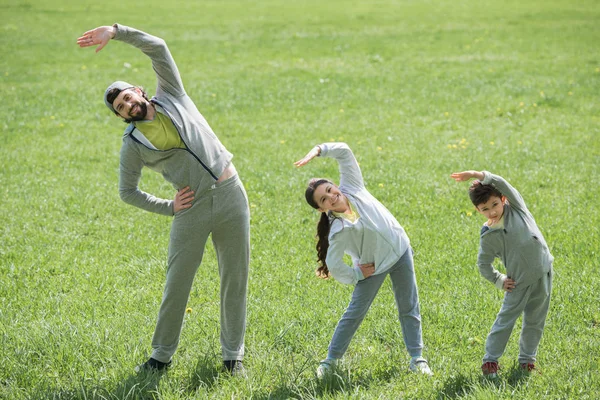 Father Daughter Son Doing Physical Exercise Grass — Stock Photo, Image