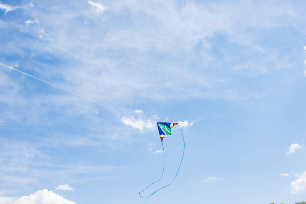 low angle view of flying kite with sky on background