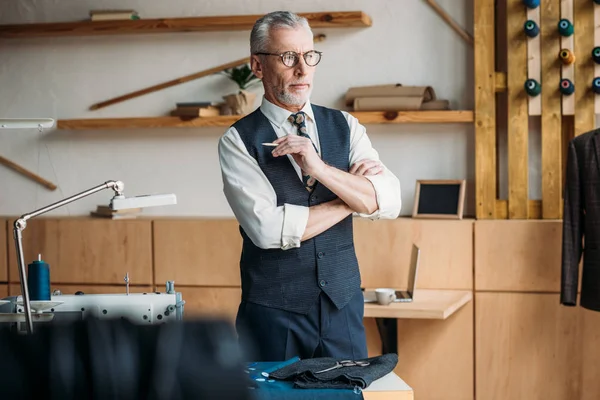 Pensive Senior Tailor Looking Away Sewing Workshop — Stock Photo, Image