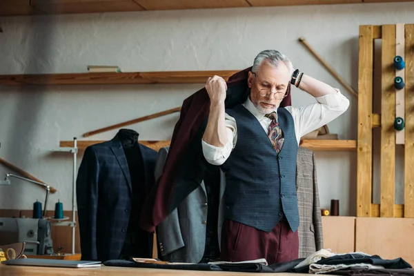 Handsome Mature Tailor Putting Jacket Shoulders Sewing Workshop — Free Stock Photo