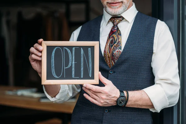 Cropped Shot Smiling Mature Tailor Holding Chalkboard Open Sign Sewing — Stock Photo, Image