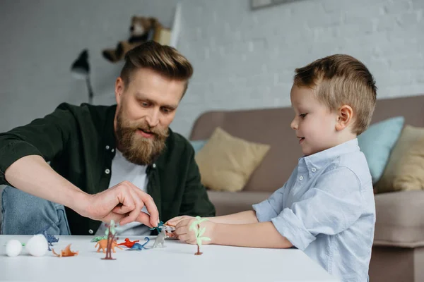 Father Cute Little Son Playing Various Toy Dinosaurs Together Home — Stock Photo, Image