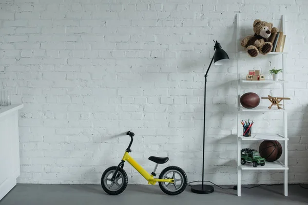 Close View Empty Childish Room Balance Bike White Brick Wall — Stok Foto